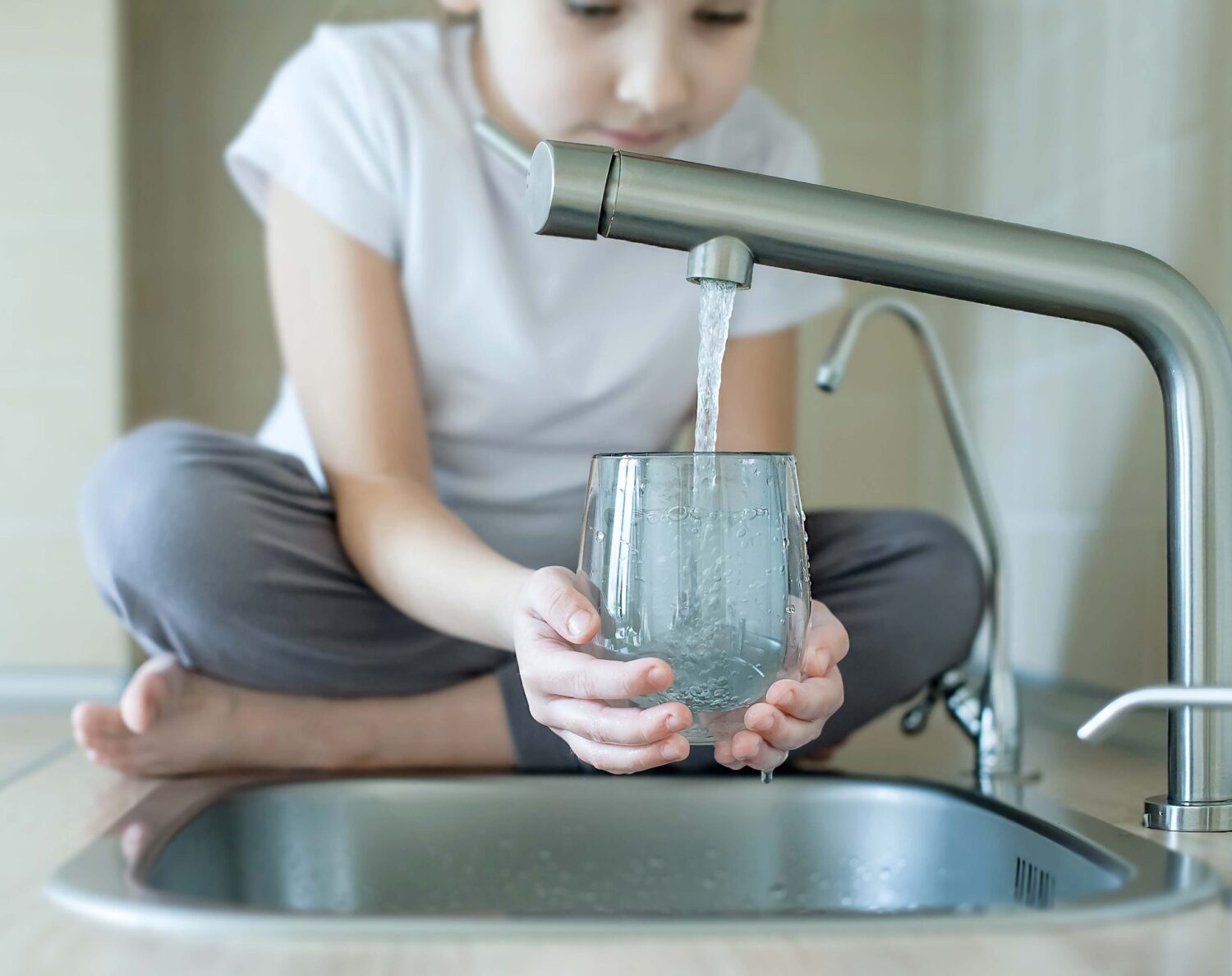 Child Open Water Tap. Kitchen Faucet. Glass Of Clean Water. Pour